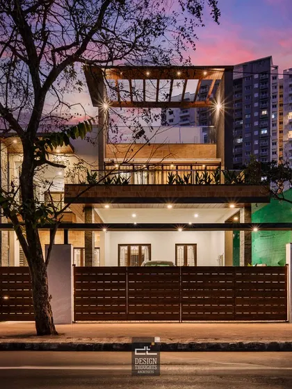 A bespoke home that blends elegance with functionality. This view shows the home at dusk, with the city lights in the background, highlighting its place as an urban oasis.