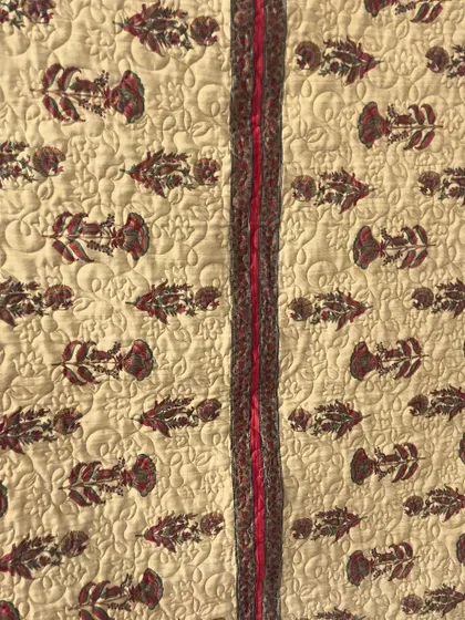 A collection of reversible memory quilts crafted from the sarees of a client's mother. Each side tells a different story, preserving the fabric's patterns and colors in a new, functional form.