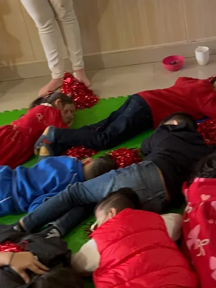 After a lot of fun and games, the children lie down for a calming "snowflake" activity, showing how we balance excitement with relaxation.