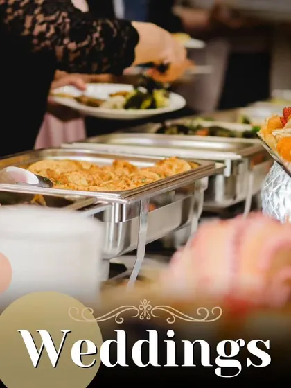 A classic buffet line at a wedding, filled with a variety of delicious dishes in chafing pans. We ensure a wide selection to please every palate at your celebration.