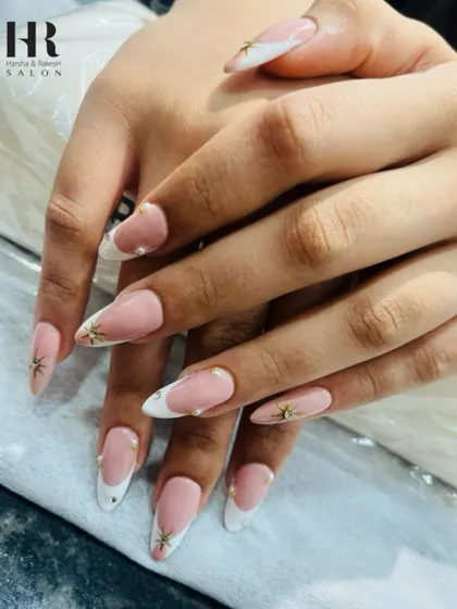 A classic French manicure with a celestial touch. We added delicate gold star charms and tiny pearl-like dots to elevate this timeless look, making it perfect for a special occasion.