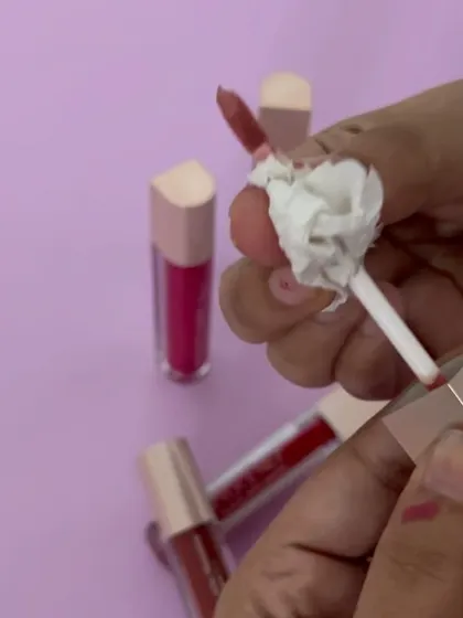 Cleaning the lipstick applicator for a perfect, clean swatch shot.