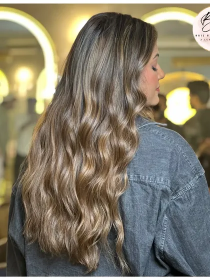 A side view of the stunning ash blonde, showing off the beautiful waves and cool tones.