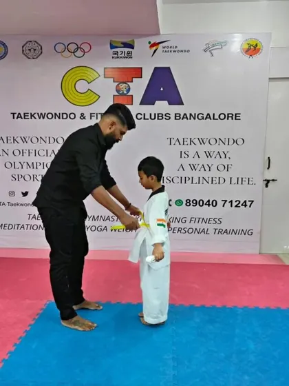 Tying a yellow belt.