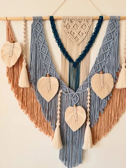 A full view of the 40-inch wide custom wall hanging with its lovely color combination of dusty blue, tan, and navy.