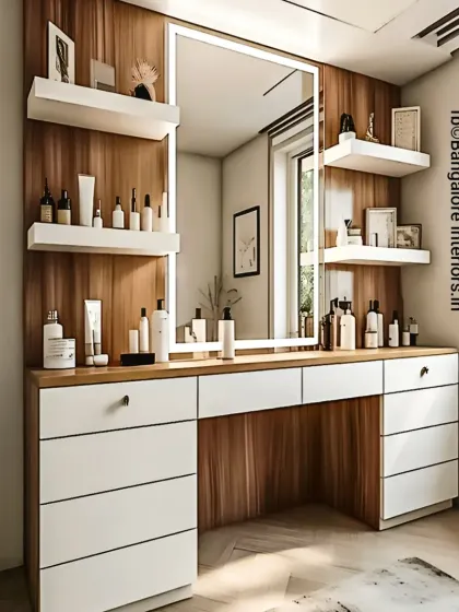 A modern and bright dressing table design. The unit combines white drawers with a wood-finish countertop and back panel, with a large, LED-bordered mirror providing perfect lighting.