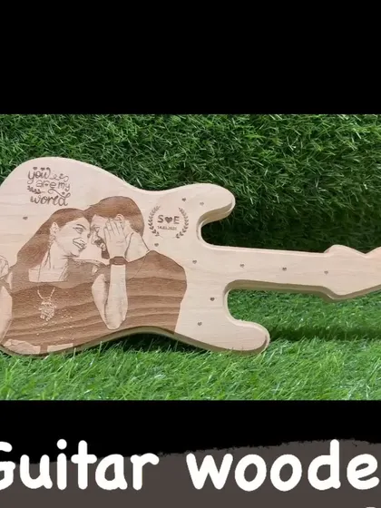 A guitar-shaped wooden plaque that can be engraved with a photo and a personal message. A perfect gift for a music lover.