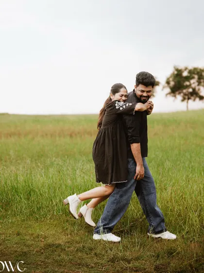 A fun piggyback ride in a field, this photo captures the playful and carefree spirit of the couple.