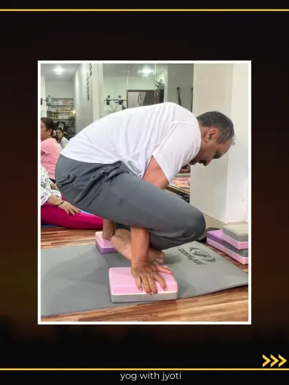 A student holds Bhujapidasana on blocks, demonstrating great arm and core strength.