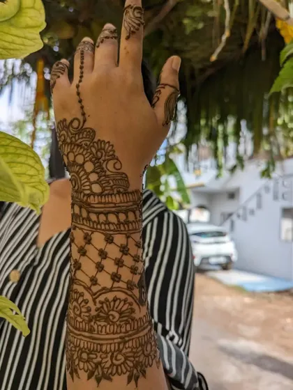 A duplicate image of the stylish cuff and chain design on the back of the hand.