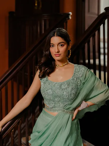 A closer look at the beautifully embroidered blouse of the sage green draped saree.