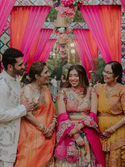 A happy family portrait during the Haldi celebrations. These events are about the union of two families, and we make sure to capture these precious group photos.