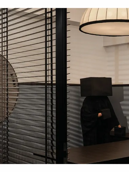 For the 'Shadows' law office, we designed large, looming light installations to give each cabin a unique identity. This sculptural light becomes the highlight of the space, visible through the glass-clad partitions.