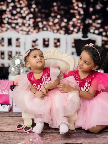 A candid moment from the Barbie shoot, where the older sister looks lovingly at her younger sister.