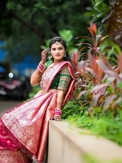 A portrait of the bride looking radiant in her pink and green silk saree. Capturing the bride in her full traditional splendor is a key part of my wedding photography service.