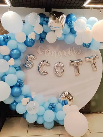 A congratulatory ring setup for Scott. This backdrop in shades of blue and white is a great way to celebrate achievements, graduations, or promotions.