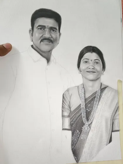 Another progress shot of the same couple's portrait. Here, the woman's saree and jewelry are fully detailed, while the man's shirt remains a blank outline.