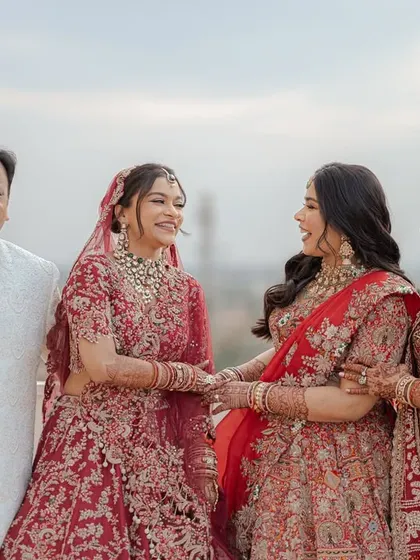 A beautiful family portrait of the bride with her parents and sister. The shared smiles and gentle hold capture the love and support surrounding her on her wedding day.