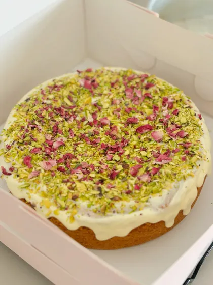 This beautiful vanilla pound cake is topped with a white chocolate glaze, pistachios, and delicate rose petals. It's a perfect example of our petite, single-serving treats.