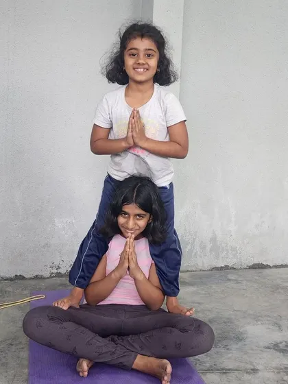 The smiles say it all. This partner pose is a fun way to build strength, balance, and friendship.