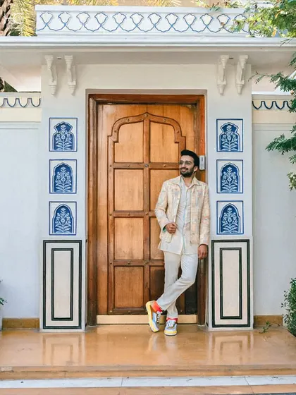 The complete look, paired with colorful sneakers, shows how to inject personality into a traditional outfit. This is modern groom style at its best.