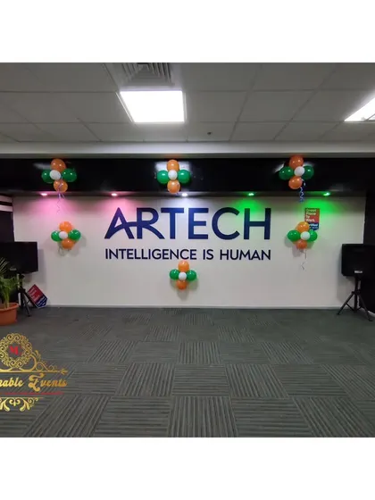 This was the main wall decoration behind the logo at Artech. Simple balloon clusters in the theme colors are an effective way to create a backdrop for photos or presentations.