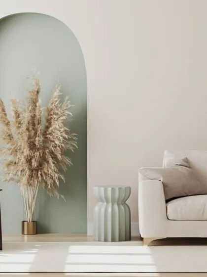A calming and minimalist interior using a combination of off-white, sage green, and natural wood tones.