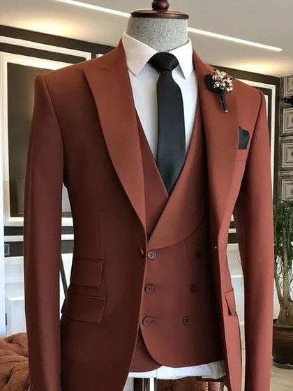 A three-piece suit in a trendy rust or brick red color. This warm and earthy tone is very stylish and perfect for autumn or winter events.