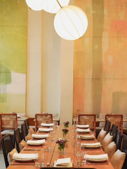 A beautifully set long table at our Malcha Marg cafe, ready for a private dinner. The warm lighting and elegant decor create a special atmosphere for any event.