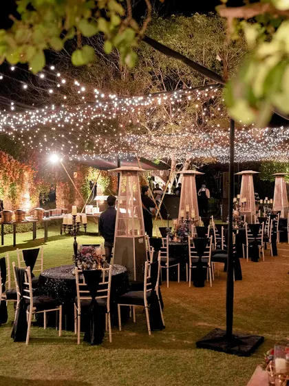 A welcome dinner under the stars. We used strings of fairy lights to create a magical canopy over the outdoor dining area, setting a warm and inviting tone for the wedding festivities.