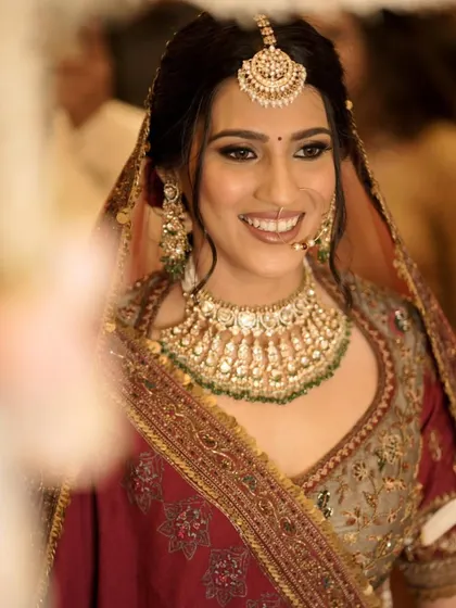 A candid shot capturing Priya's bridal glow. The makeup was kept fresh and luminous to highlight her natural beauty and her stunning traditional attire.