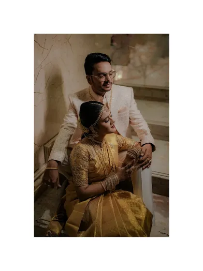 An elegant, posed portrait of the couple on a staircase, with a moody and classic feel.