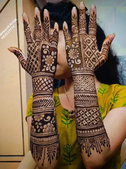 A beautiful example of a full-coverage back-of-hand design. The patterns are a mix of floral motifs and jaali work, creating a rich texture.