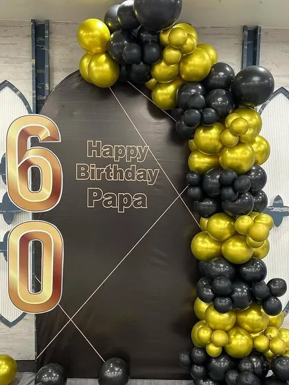 Another angle of the sophisticated black and gold 60th birthday setup.