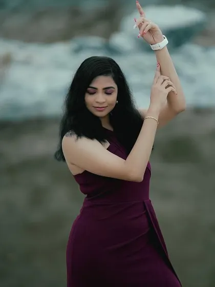 A graceful pose from a pre-wedding shoot. I created a soft glam look with a plum-colored dress, using subtle makeup to enhance her natural beauty against the scenic backdrop.