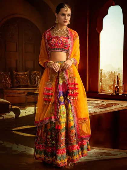 This colorful ethnic wear is set against a projected heritage interior. The lighting is balanced to bring out the vibrancy of both the outfit and the intricate background.