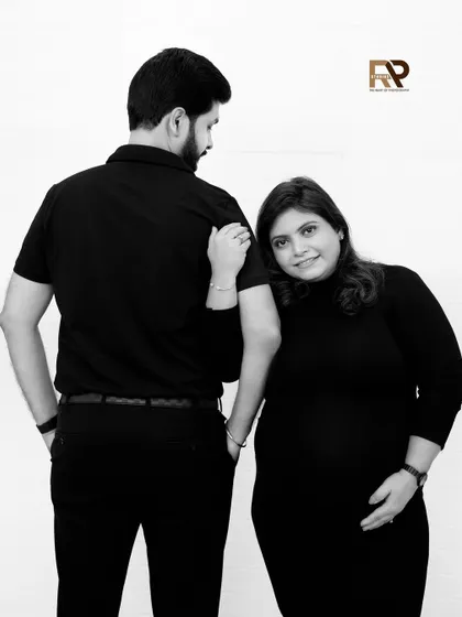 A sweet and intimate pose. The mom-to-be rests her head on her partner's back, a simple gesture that speaks volumes about their bond.