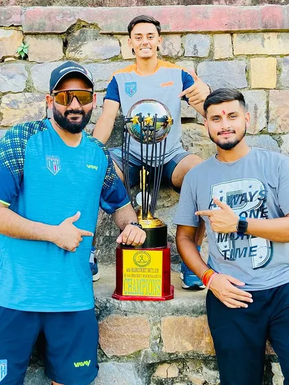 The coaching team celebrating with the trophy. A proud moment for all of us.