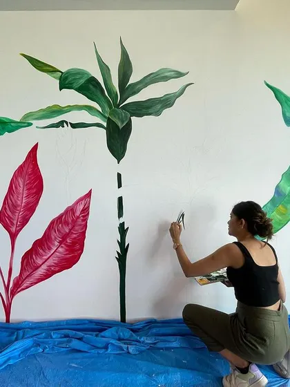 Me in my element, surrounded by paints and a large tropical wall in progress. This is my happy place.