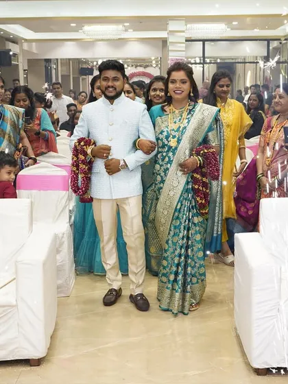 A grand entrance for the couple at their reception, surrounded by friends and family.