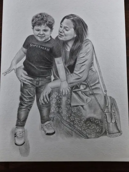 A tender moment between a mother and her son, drawn with graphite pencil. These family portraits are designed to be treasured for years.