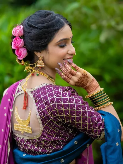 A closer look at the elegant floral bun and the custom blouse with a chandrakor motif. I believe hairstyling is just as crucial as makeup in completing the bridal vision.
