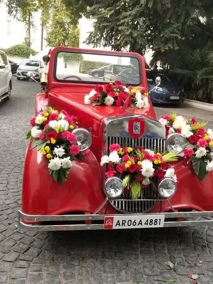 A vintage car for the groom's entry adds a touch of royal charm. After all, a wedding doesn't happen every day, and we believe in making the baraat as grand as possible.