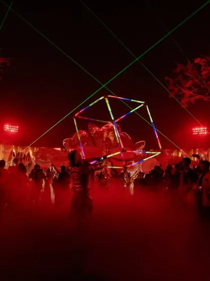A performer manipulates an LED cube, creating geometric light patterns that mesmerize the crowd. This is how I create an immersive, club-like atmosphere.