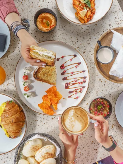A beautiful flat-lay of a Middle Eastern breakfast spread. This type of shot is excellent for showcasing menu variety and the overall dining experience a cafe offers.