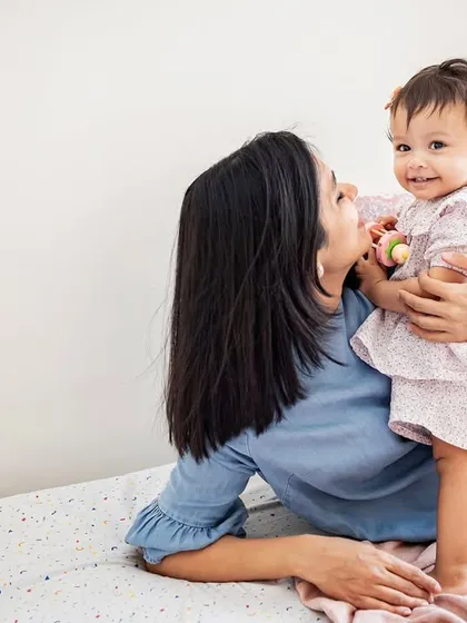 A sweet mother-daughter moment during a lifestyle session. I love capturing these natural cuddles and playtime scenes on the bed.