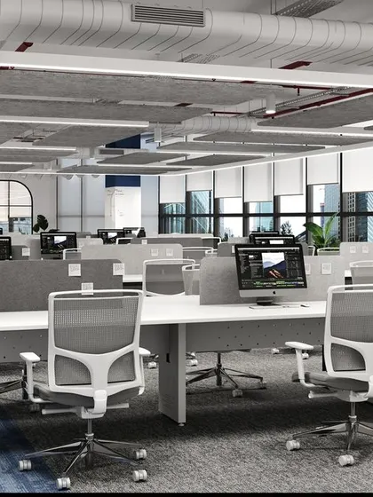 A modern and minimalist workstation setup, featuring clean white desks, ergonomic chairs, and subtle blue accents. The design prioritizes an uncluttered environment to help employees focus on their tasks.