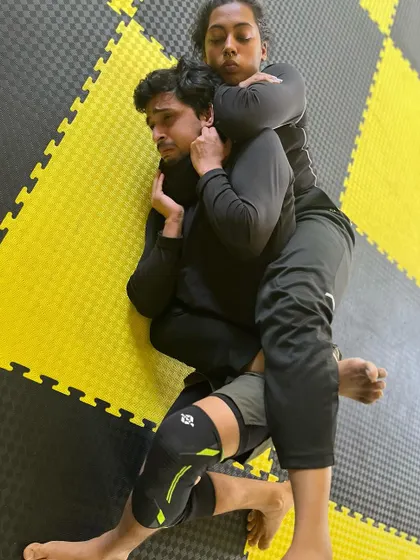 A focused shot of a back control position in BJJ. This is a dominant position from which to attack.