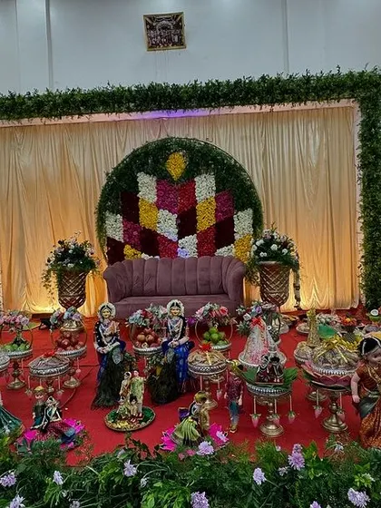 A wide shot of a platter setup in a hall, showing the behind-the-scenes lighting equipment.