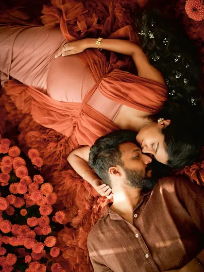 An artistic overhead shot capturing the deep connection between a couple, surrounded by a bed of flowers. A truly magical way to remember this time.
